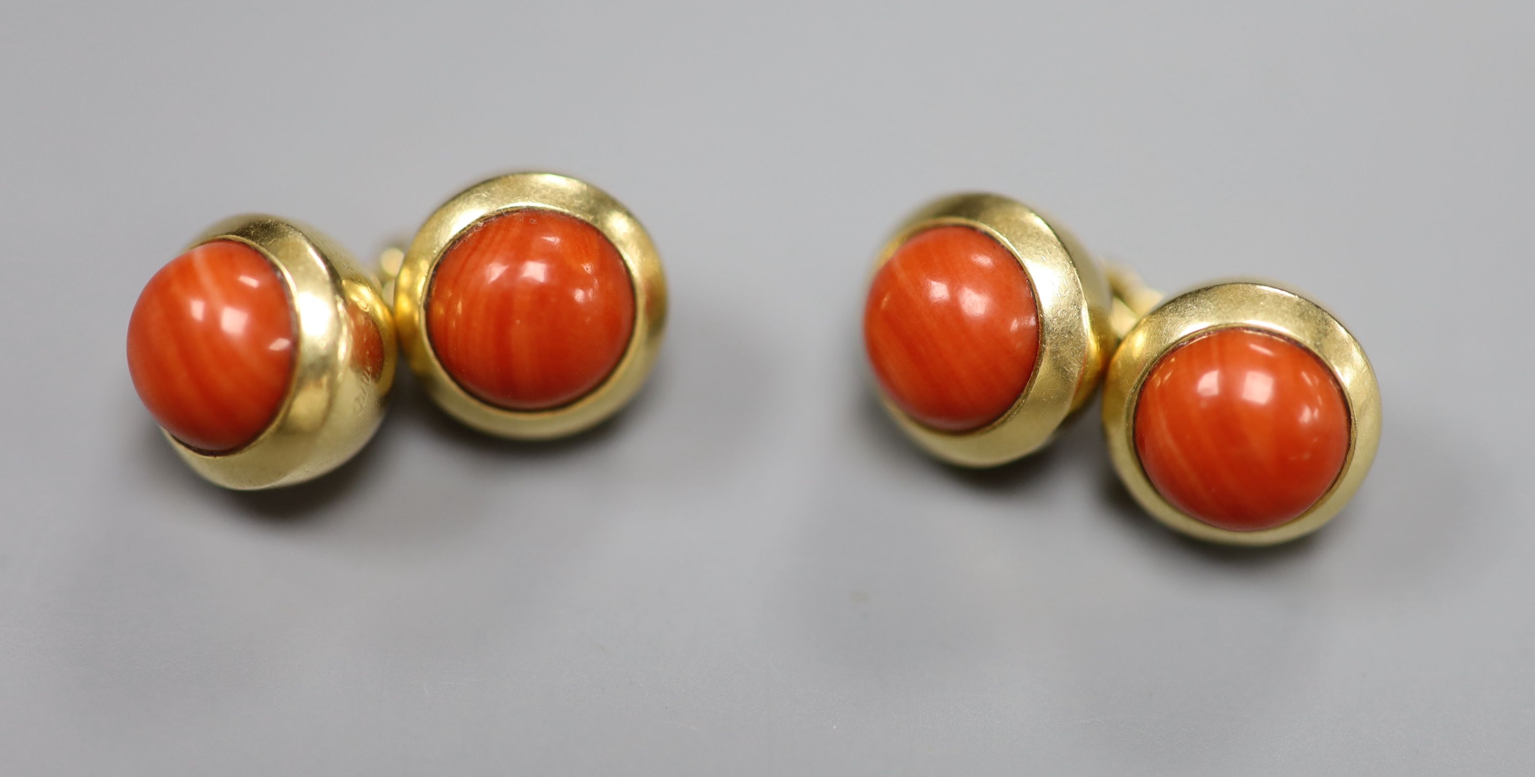 A pair of Cartier 750 yellow metal and coral bead set spherical cufflinks,